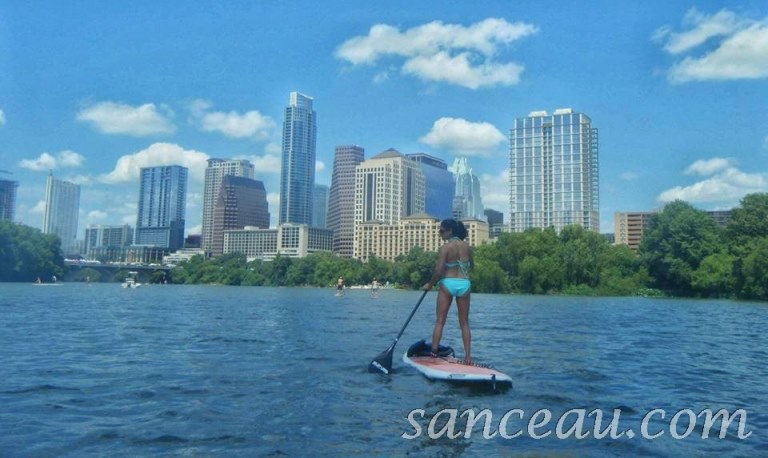 My gorgeous and fit friend, Brenda, paddleboarding, with view of Austin skyline