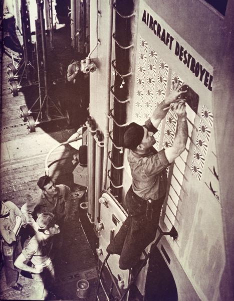 WWII sailor painting a fresh kill on the carrier scoreboard (Time-Life)